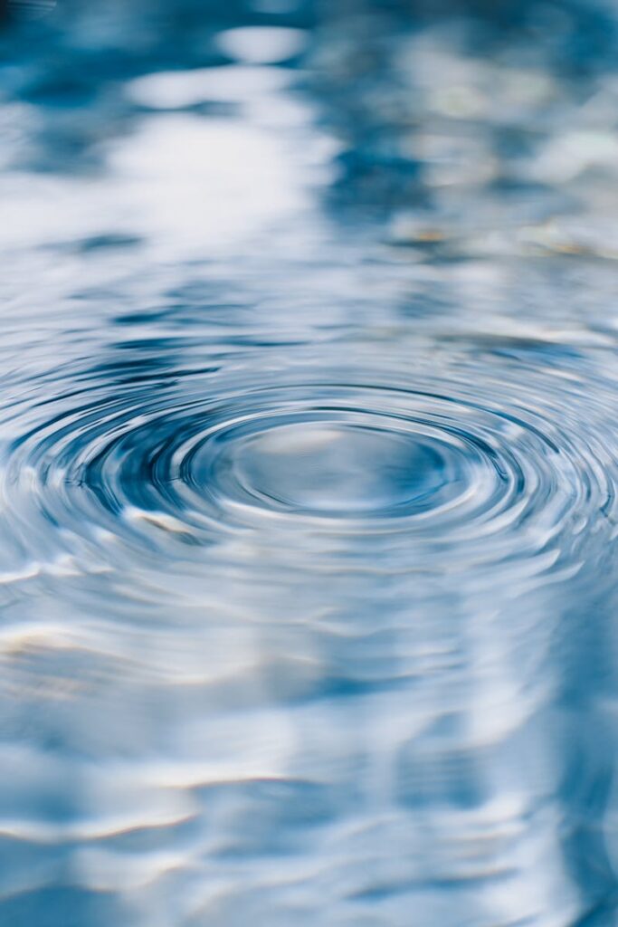 Serene ripples on clear blue water, capturing tranquility and purity.